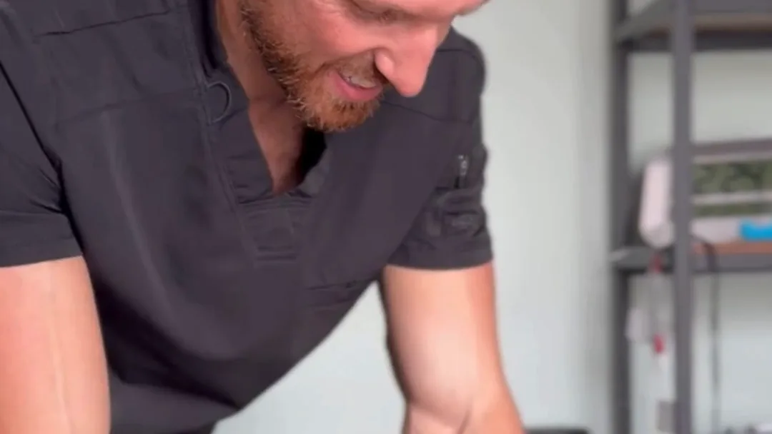 A Spinal Solutions chiropractor at the treatment table in the St. Augustine clinic