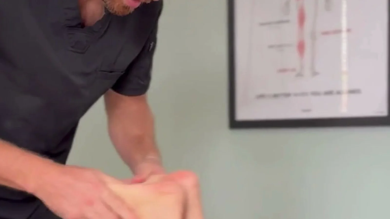 Hands-on soft tissue work on a limb during a visit at Spinal Solutions in St. Augustine